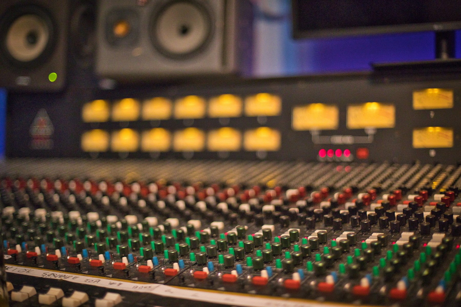 Studio mixing console in warm, low light